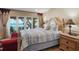 Cozy bedroom with ocean view, featuring access to outdoor seating and natural light at 13033 Se 158Th Ln, Weirsdale, FL 32195