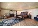 Spacious bedroom with wood floors, ornate furniture, and a comfortable sitting area at 13033 Se 158Th Ln, Weirsdale, FL 32195