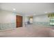 Large bonus room with tiled floors, decorative molding, and ample natural light from the windows at 13033 Se 158Th Ln, Weirsdale, FL 32195