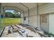 Outdoor car port with a boat trailer parked in front of a white wall at 13033 Se 158Th Ln, Weirsdale, FL 32195