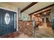 Inviting entryway featuring a brick accent wall and view into the modern kitchen at 13033 Se 158Th Ln, Weirsdale, FL 32195