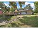 Beautiful brick home with a large deck and well-maintained landscaping at 13033 Se 158Th Ln, Weirsdale, FL 32195