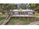 Charming brick home featuring a spacious deck with scenic views and lakeside access at 13033 Se 158Th Ln, Weirsdale, FL 32195