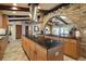 Gourmet kitchen with a large island, granite countertops, and a brick archway, perfect for culinary enthusiasts at 13033 Se 158Th Ln, Weirsdale, FL 32195