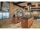 Open concept kitchen with brick archway, stainless steel appliances, and ample counter space at 13033 Se 158Th Ln, Weirsdale, FL 32195