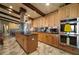 Modern kitchen featuring stainless steel appliances, central island, and marble floors at 13033 Se 158Th Ln, Weirsdale, FL 32195