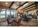 Inviting living room boasts high ceilings, exposed beams, a brick fireplace, and stunning water views at 13033 Se 158Th Ln, Weirsdale, FL 32195