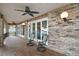 Charming brick patio featuring comfortable seating and elegant lighting, perfect for outdoor relaxation at 13033 Se 158Th Ln, Weirsdale, FL 32195