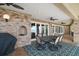 Outdoor patio featuring brick accents, ceiling fans, and an outdoor grill with seating area offering lake views at 13033 Se 158Th Ln, Weirsdale, FL 32195