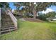 Lush green lawn and mature shade trees leading to lake at 13033 Se 158Th Ln, Weirsdale, FL 32195