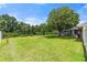 A sprawling green backyard features a fire pit with plenty of space at 135 N James Pl, Groveland, FL 34736