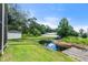A serene backyard featuring a tranquil pond and a wooden dock, perfect for enjoying nature at 135 N James Pl, Groveland, FL 34736