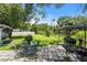 Backyard is perfect for outdoor grilling and relaxing, features gazebo, grill, table and chairs at 135 N James Pl, Groveland, FL 34736