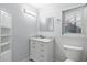 Bathroom with white vanity, marble countertop, and storage shelves at 135 N James Pl, Groveland, FL 34736