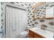 A cozy bathroom features a shower-tub combination and a decorative mirror at 135 N James Pl, Groveland, FL 34736