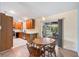Dining area adjacent to kitchen with sliding glass doors to screened lanai at 135 N James Pl, Groveland, FL 34736