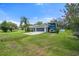 Attractive home with a two-car garage and RV parking, complemented by lush landscaping and a well-maintained lawn at 135 N James Pl, Groveland, FL 34736