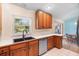 Functional kitchen with dark sink, ample cabinetry, white countertops and tile flooring at 135 N James Pl, Groveland, FL 34736