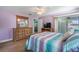 Spacious main bedroom featuring wood floors, dresser, and access to a screened lanai at 135 N James Pl, Groveland, FL 34736