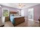 Cozy main bedroom with wood floors, natural light and ensuite bathroom at 135 N James Pl, Groveland, FL 34736