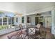 Screened lanai offers a comfortable space with outdoor seating and ceiling fan at 135 N James Pl, Groveland, FL 34736