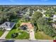 Overview of a property showcasing a well-maintained lawn, mature trees, and a charming residential neighborhood at 13700 Se 90Th Ct, Summerfield, FL 34491