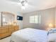 Bright bedroom boasts a large dresser with mirror and mounted TV at 13700 Se 90Th Ct, Summerfield, FL 34491