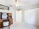 Clean bedroom with a ceiling fan and a pair of closets at 13700 Se 90Th Ct, Summerfield, FL 34491