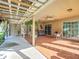 Charming covered patio, perfect for relaxation, offering picturesque views of the expansive backyard and lush greenery at 13700 Se 90Th Ct, Summerfield, FL 34491