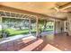 Spacious covered patio providing a shaded retreat with views of the beautifully landscaped lawn and garden area at 13700 Se 90Th Ct, Summerfield, FL 34491