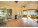 Inviting covered patio featuring tile flooring, a ceiling fan, and a serene outdoor seating area with an arched lattice accent at 13700 Se 90Th Ct, Summerfield, FL 34491