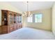 Dining room featuring chandelier lighting, a large cabinet, neutral walls, and bright natural lighting at 13700 Se 90Th Ct, Summerfield, FL 34491