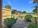 Charming home exterior featuring manicured landscaping and a stone pathway leading to the entrance at 13700 Se 90Th Ct, Summerfield, FL 34491