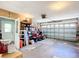 Spacious garage featuring an automatic door, ample storage space, and a side door at 13700 Se 90Th Ct, Summerfield, FL 34491