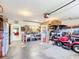 Large garage with plenty of room for a lawnmower and storage at 13700 Se 90Th Ct, Summerfield, FL 34491