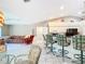 Open-concept layout featuring a kitchen with bar seating, and open living area with tile flooring at 13700 Se 90Th Ct, Summerfield, FL 34491