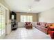 Bright and airy living room featuring large windows, comfortable seating, and tile flooring at 13700 Se 90Th Ct, Summerfield, FL 34491