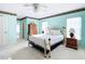 Main bedroom with light blue walls, large windows, brass bed frame, and ensuite access at 13700 Se 90Th Ct, Summerfield, FL 34491