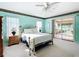 Spacious main bedroom with sliding glass doors, neutral carpet, and light blue walls at 13700 Se 90Th Ct, Summerfield, FL 34491