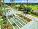 Shuffleboard courts with covered seating, surrounded by palm trees, offering residents a fun outdoor activity at 13700 Se 90Th Ct, Summerfield, FL 34491