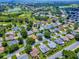 Gorgeous aerial view of a sunny residential community, golf course, and lakes at 1419 Arbor Trl, The Villages, FL 32162