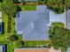Aerial view of the home with well-maintained landscaping and a neatly paved driveway at 1419 Arbor Trl, The Villages, FL 32162
