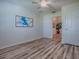 Bright bedroom with a ceiling fan, laminated flooring, and a glimpse of the other rooms at 1419 Arbor Trl, The Villages, FL 32162