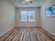 Well-lit bedroom showcasing laminated flooring and a window providing ample natural light at 1419 Arbor Trl, The Villages, FL 32162