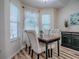 Comfortable dining area featuring natural light, a wood table, and contemporary seating, perfect for intimate gatherings at 1419 Arbor Trl, The Villages, FL 32162