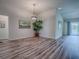 Dining area with wood floors, a modern chandelier, and a view of the adjoining rooms at 1419 Arbor Trl, The Villages, FL 32162