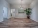 Open dining area with wood floors, pendant lighting, and a bright, airy feel at 1419 Arbor Trl, The Villages, FL 32162