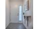 Bright entryway featuring tile flooring, a decorative shelf, and a classic white front door at 1419 Arbor Trl, The Villages, FL 32162