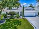 Charming one-story home with well-manicured lawn and mature trees at 1419 Arbor Trl, The Villages, FL 32162