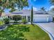 Charming one-story home with well-manicured lawn and mature trees at 1419 Arbor Trl, The Villages, FL 32162